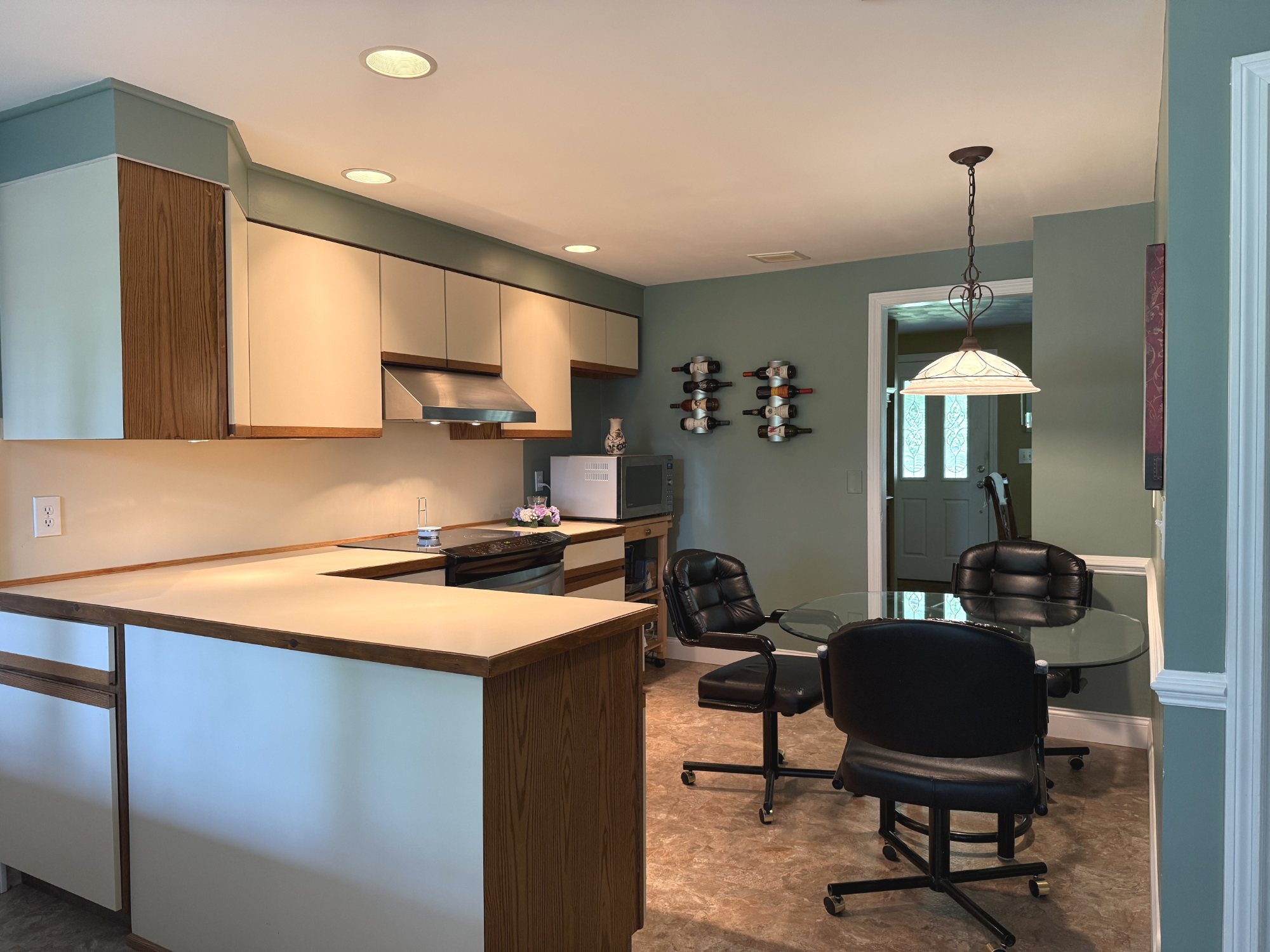 Shared full kitchen with counter space, stove, refrigerator, and microwave