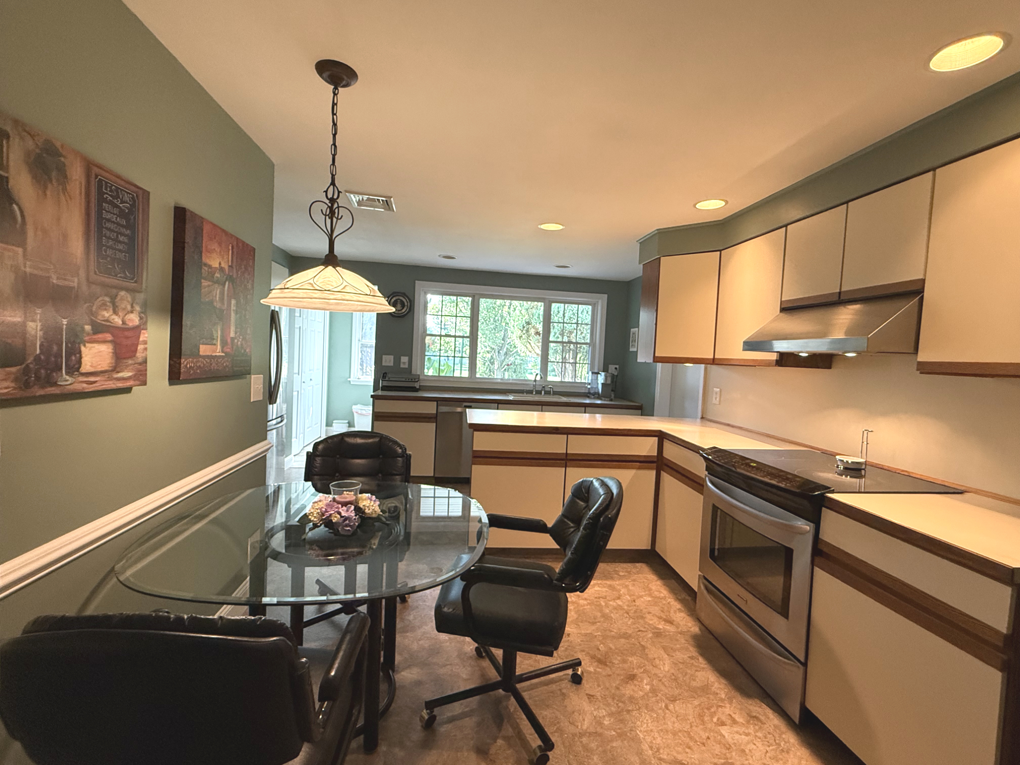 Clean shared kitchen with dining nook and full appliance access